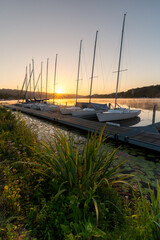 Sailboats in the marina on Lake Baldeneysee in Essen at sunrise. Vertical view
