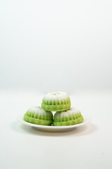 "Kue Putu Ayu"  steamed rice cakes found in Southeast Asian culinary traditions, often flavored with pandan and topped with grated coconut.