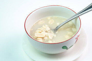 a bowl of huāshēng tángshuǐ or Wedang Kacang, a popular dessert in Southeast Asia with Chinese-Peranakan influences. The warm sweet soup, with a base of blanched