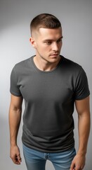 Fototapeta premium Studio shot of a stylish young man in a minimalist dark t-shirt and jeans, exuding contemporary charm.