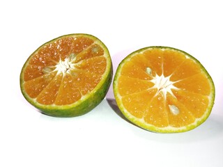 Fresh orange fruit cut in half, isolated on white background..