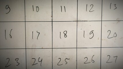 Calendar Days Marked on a White Board, Black Marker Numbered Days from 9 to 27 in a Grid Pattern ,...