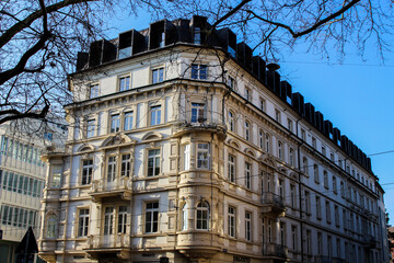 sand-colored stucco-clad building in Freiburg is illuminated by the winter sun