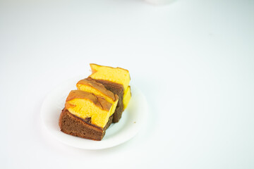 slices of Lapis Surabaya, a famous Indonesian layer cake. A simple, minimalist food shot with ample copy space for text or other graphic elements.