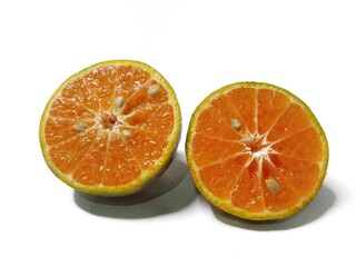 Fresh orange fruit cut in half, isolated on white background. Citrus photography, healthy tropical fruit, vitamin C, natural food, diet and nutrition concept.