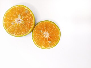 Fresh orange fruit cut in half, isolated on white background. Citrus photography, healthy tropical fruit, vitamin C, natural food, diet and nutrition concept.