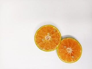 Fresh orange fruit cut in half, isolated on white background. Citrus photography, healthy tropical fruit, vitamin C, natural food, diet and nutrition concept.