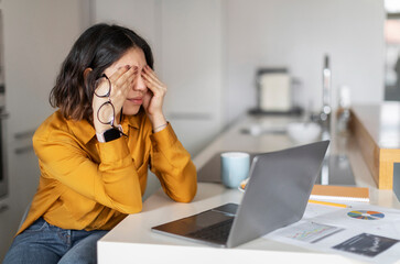 Tired Young Arab Woman Feeling Eyes Strain After Using Laptop At Home, Millennial Middle Eastern...