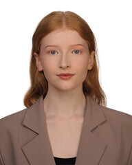 portrait of a twenty year old red-haired girl with model appearance in a jacket on a white...