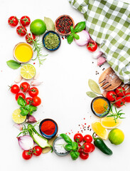 Healthy food cooking frame background with spices, herbs, turmeric, chili powder, towel and kitchen utensils, white table, top view