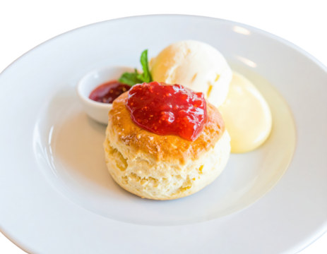 Golden baked English scone topped with strawberry jam served with clotted cream and mint.