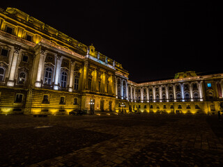 Budapest, Hungary &ndash; Night view of the illuminated Buda Castle courtyard and Royal Palace architecture.