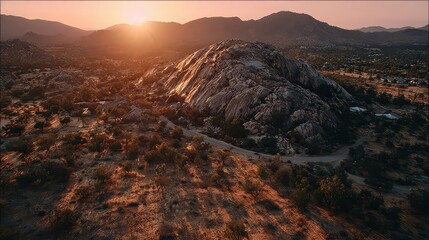 Fototapeta premium Sunset Over Rocky Hills And Cityscape