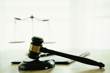 A gavel on a desk represents law, justice, and authority, symbolizing courtroom judgment, legal decisions, contracts, agreements, punishment, innocence, and the balance of the judicial system.