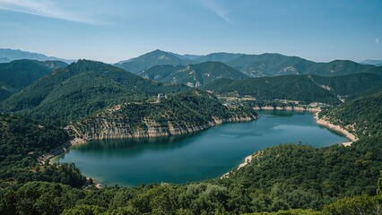 Breathtaking Bird's-Eye Perspective of a Lake Enclosed by Vibrant Green Hills and Peaks