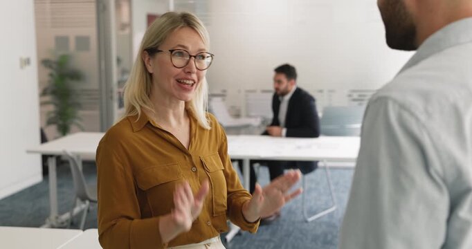 Two professionals shaking hands standing in modern corporate meeting office, respectful gesture of successful agreement, partnership and mutual understanding. Business collaboration, trust, services