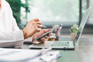 Businesswoman manages finances by using banking and accounting system to calculate costs, taxes,...