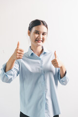 Asian woman rejoicing, looking happy, champion, fist pump gesture, standing over white background. young woman had happy, positive expression on her face, highlighted by bright smile.