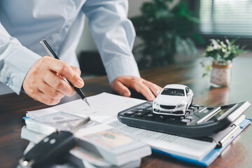 Customer signing insurance document lease agreement table, writing signature contract buying...