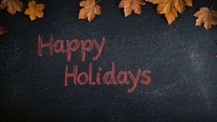 Festive Greetings Scrawled in Red Chalk on a Dark Chalkboard Set Against a Rustic Wooden Surface with Autumnal Ornaments in Focus