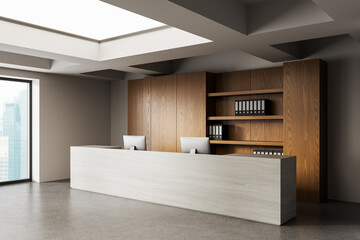 Modern office reception area with minimalist white desk and wooden shelving, illuminated by natural...