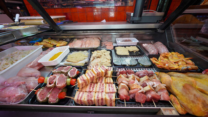 Traditional butcher shop meat display counter filled with fresh cuts for customers