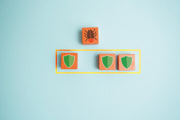 Network virus icon facing shields representing cybersecurity defense