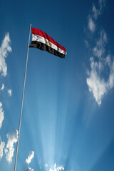 Waving National flag of Egypt on flagpole in sky