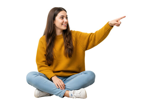 Young woman sitting cross legged pointing to the side isolated on transparent background