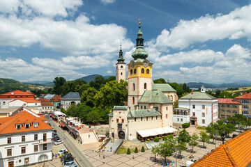 Obraz premium Church of the Assumption of the Virgin Mary dominating Namestie Stefana Moysesa square in Banska Bystrica, Slovakia