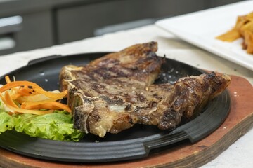 Grilled meat cooking on a barbecue with smoke rising, ready to be served at a feast