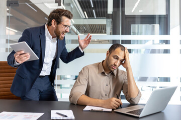 An office environment depicting conflict, with a manager angrily pointing at an employee focused on...