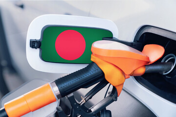 The flag of Bangladesh on the hatch of the gas tank of a car at a gas station. Gasoline and diesel...
