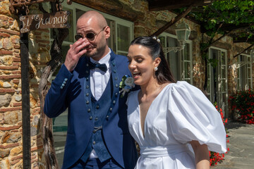 Happy newlyweds enjoying the festive party at the villa surrounded by loved ones and relatives