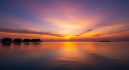 Obraz premium Sunset over water bungalows