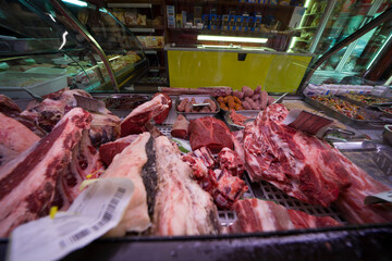 Traditional butcher shop meat display counter filled with fresh cuts for customers