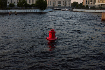 A Bright Red Fire Hydrant Nestled Among Bountiful Water Sources, Creating a Striking Scene