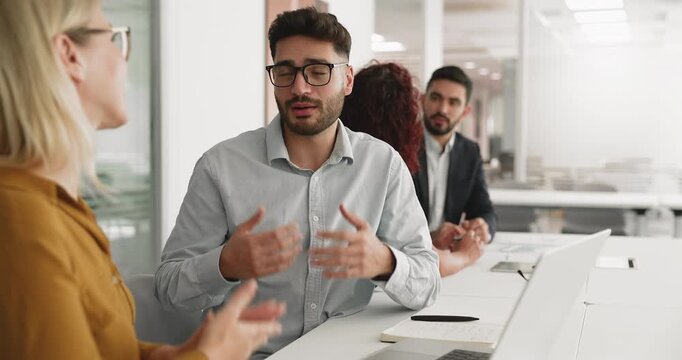 European and Arabian business partners sit at desk with laptop, lead conversation, making business deal, concluding agreement and partnership, finalize negotiations with handshake as gesture of trust