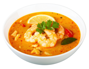 Spicy Thai Tom Yum Goong soup with large prawns fresh herbs and a lemon slice in a white bowl.