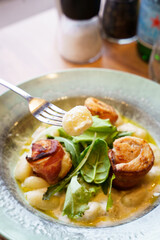 Gnocchi with creamy sauce and bacon-wrapped chicken