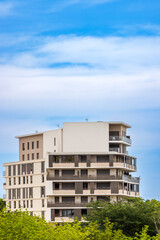 Modern Apartment Building with Balconies in Montpellier, France, under a Blue Sky