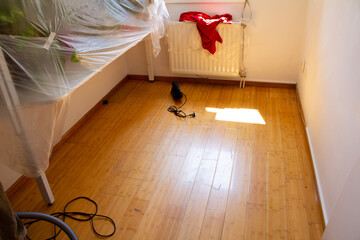 damaged parquet that is being prepared for repair, a sander for sanding parquet and a wardrobe...