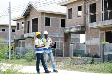 Male engineer holding a laptop and working at a construction site – engineering and architectural...
