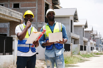Male engineer holding a laptop and working at a construction site – engineering and architectural...