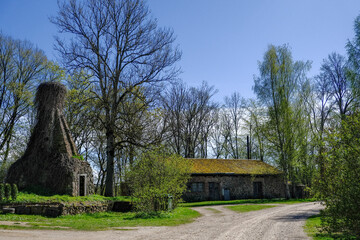 old buildings on country road side. Latvia, Mazsalaca