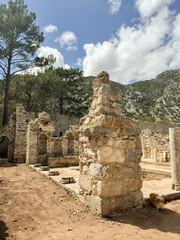 Ancient ruins nestled in a mountainous landscape under a blue sky