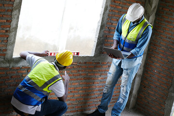 Male engineer holding a laptop and working at a construction site – engineering and architectural...