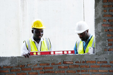 Male engineer holding a laptop and working at a construction site – engineering and architectural...