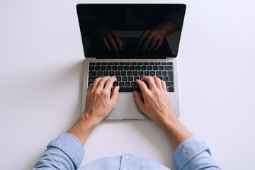 Fototapeta premium Hands Typing on Laptop Keyboard - Overhead View of Remote Work and Technology