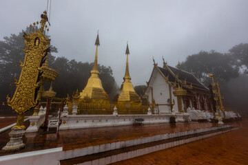 The background of the religious tourist attraction Wat Phra That Doi Tung in the mist in Chiang Rai...